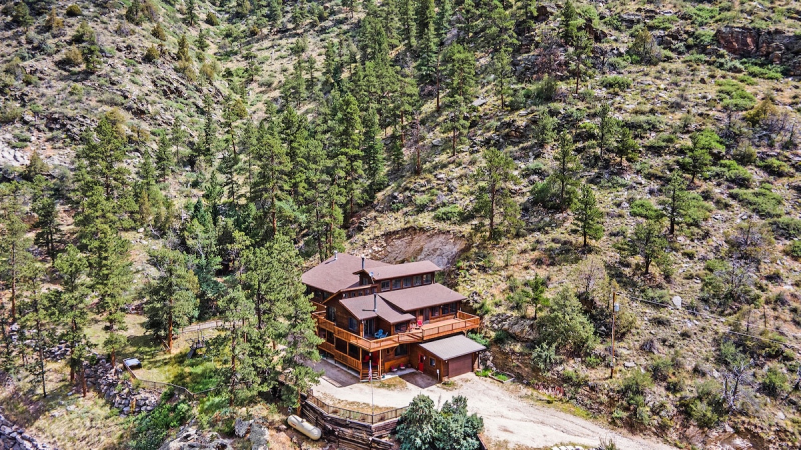 Aerial view of the lodge nestled in the canyon, surrounded by ponderosa pines